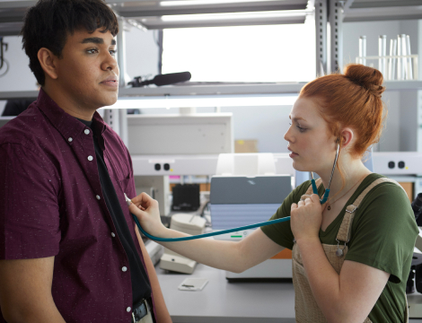Health student using a stethoscope