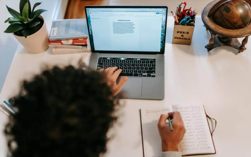 Student writing on computer