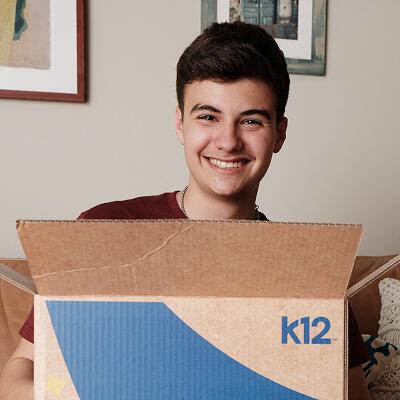 Noah, student, holding a box